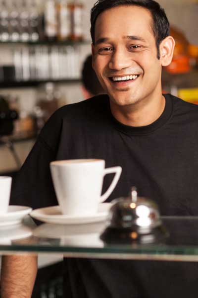 Customer smiling while reaching for sandwich and chips